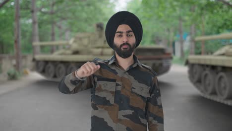 disappointed sikh indian army man showing thumbs down