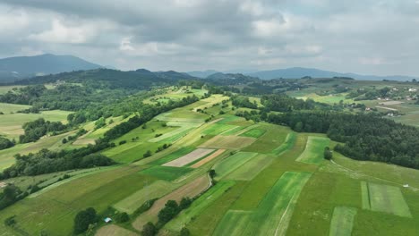 polish farmland with beskid mountain range, hillside land scenic aerial