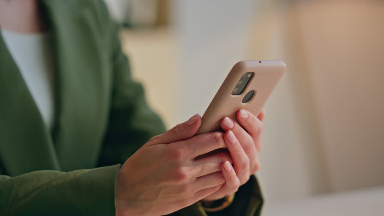 Woman hands holding cellphone office closeup. Businesswoman using mobile phone