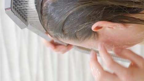 caring for long hair, woman taking a shower in the bathroom. close up