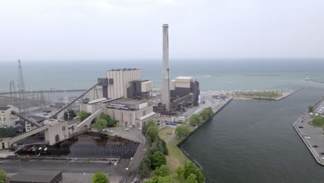 power generating plant along lake, michigan in michigan city, indiana with drone video moving sideways