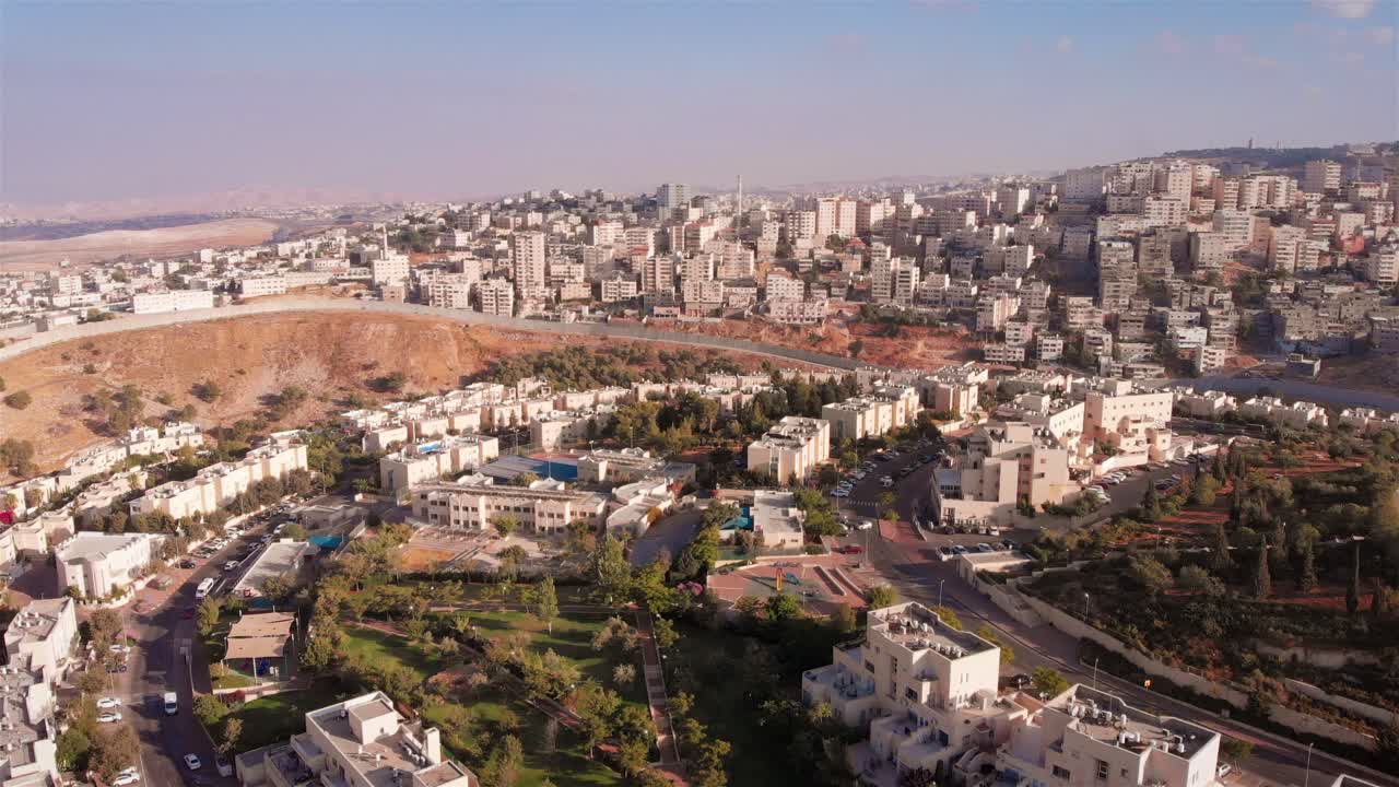 Aerial View of a Densely Built Cityscape with a Separation Barrier