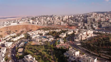 aerial view of a densely built cityscape with a separation barrier