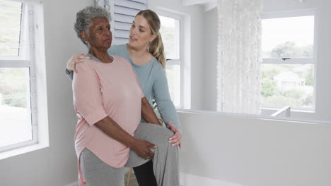 Caucasian-nurse-with-senior-woman-exercising,-copy-space,-slow-motion