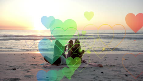 animation of hearts moving over diverse couple in love lying on beach in summer