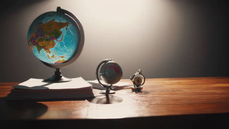 vintage globe and compass on a desk