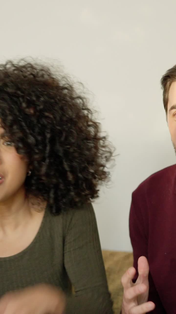 Multiethnic couple celebrating that their football team win a match