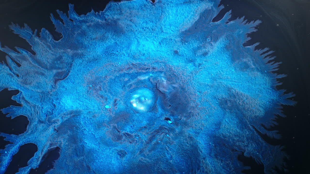 Bright blue liquid swirl dissolving in water, macro view, calm motion