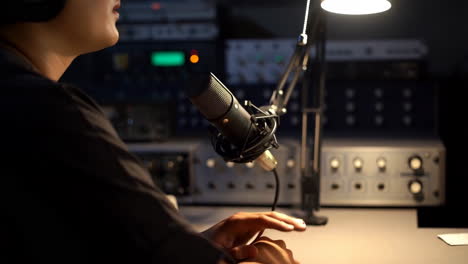 person recording with a microphone in a professional audio studio