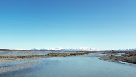 flying low downstream above beautiful rakaia river on a calm, cold mid-winter's morning - vast landscape, big sky and stunning mountains