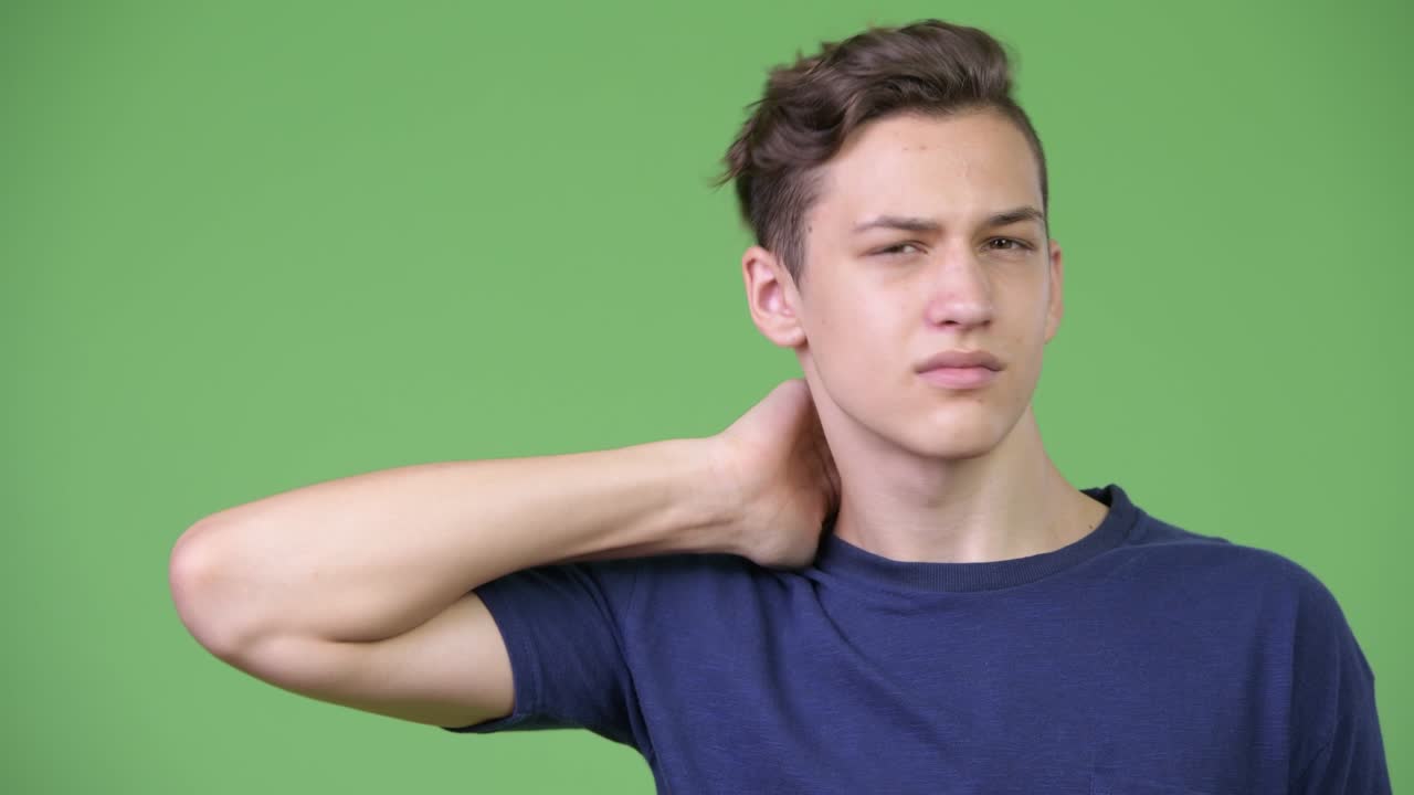 Young handsome teenage boy having neck pain