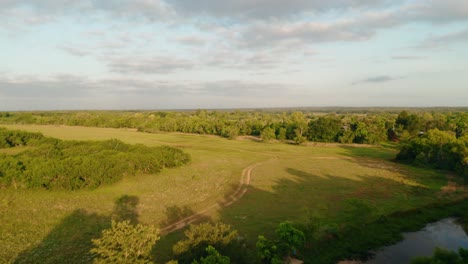 Aerial-drone-fly-over-stream-and-vast-nature-on-ranch-land-in-Texas