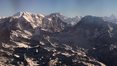 an aerial view flyby of the himalayan mountains of nepal on a clear day