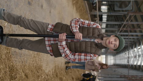 vertical portrait of teenage boy at cattle farm