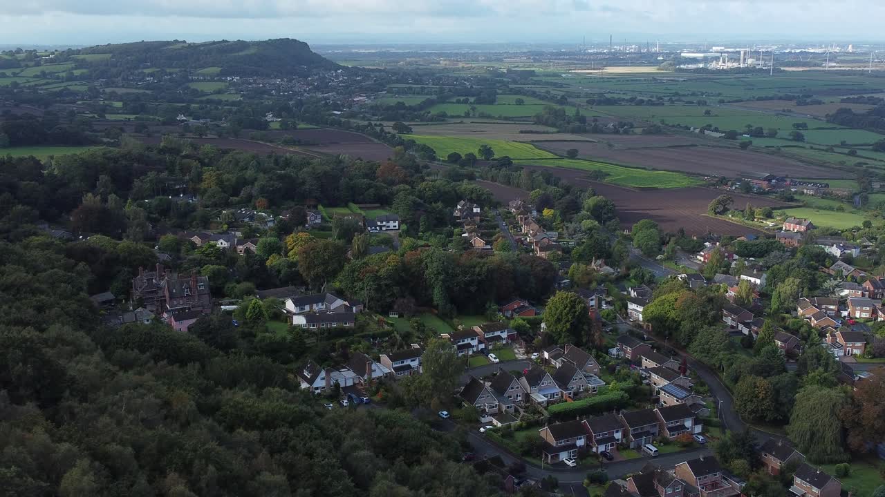 Aerial view above Cheshire North England viewpoint out across Snowdonia North Wales vast countryside orbiting left shot