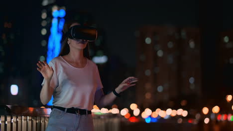 a young girl in virtual reality glasses in a large metropolis simulates work in the program game virtual reality interface. the concept of augmented reality