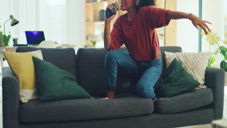 Black-woman,-dance-on-sofa-and-relax-with-freedom