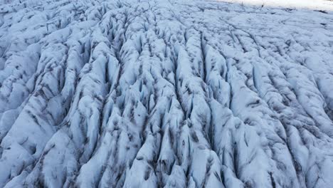 jagged split surface of icy glacier in iceland, virkisjökull, aerial