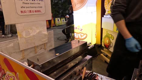 preparing and cooking cheese pancakes at a stall.