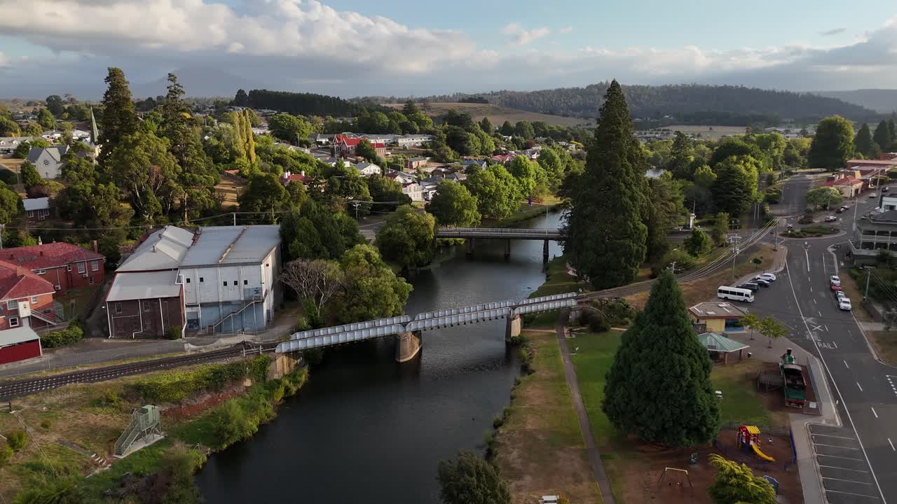 Railway bridge on Meander River, Deloraine Town at sunset, Tasmania in Australia. Aerial drone panoramic view
