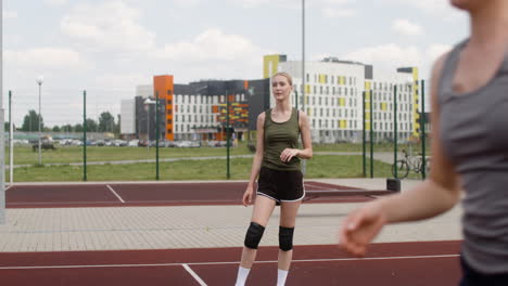 blonde woman hitting a volleyball