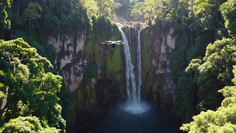drone view of a waterfall in a lush jungle