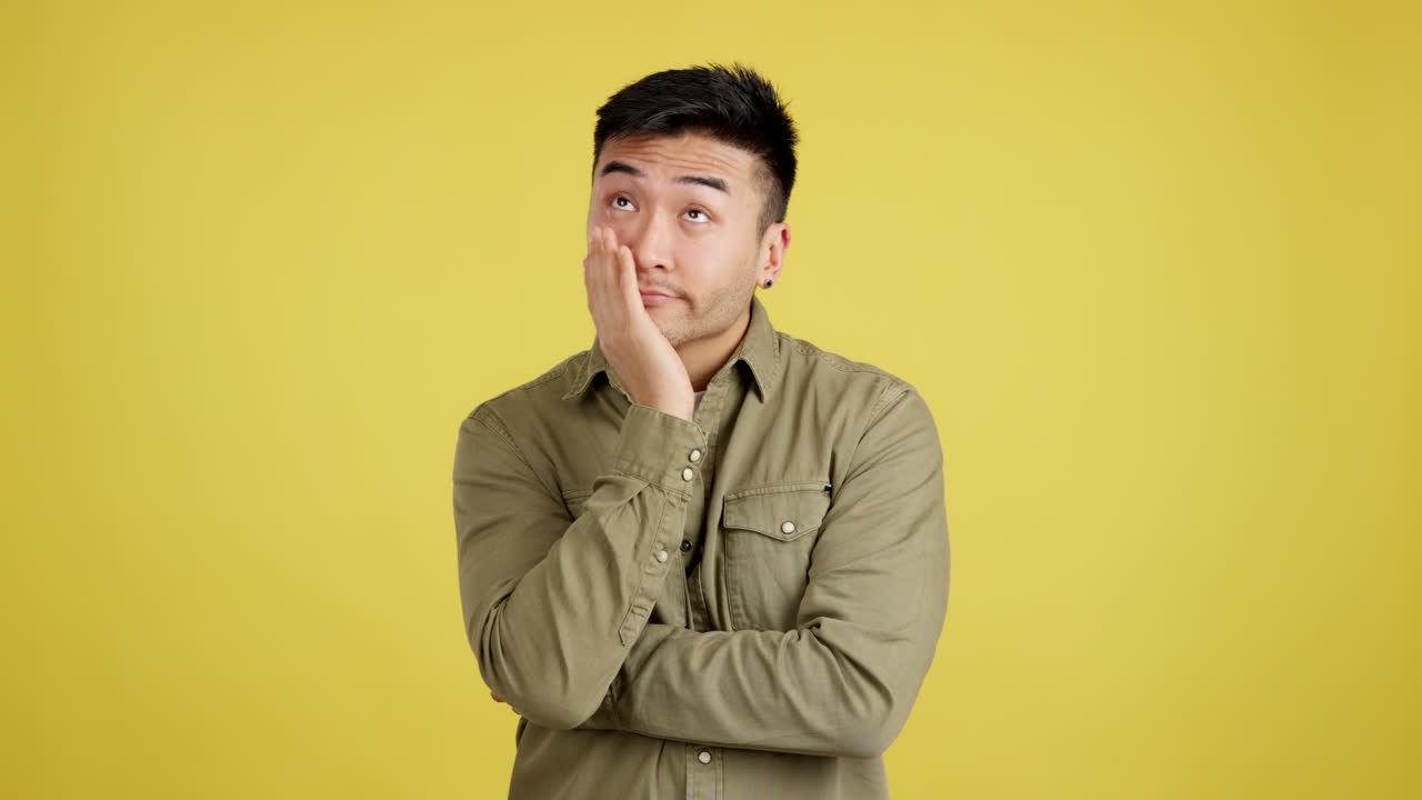 Young Asian Man Expressing Boredom and Annoyance