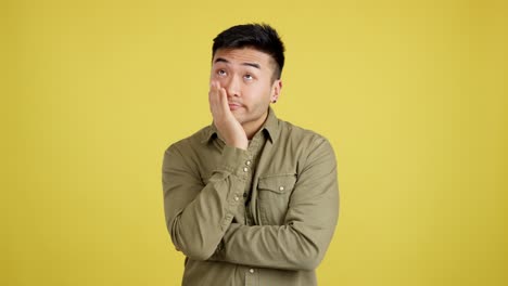 young asian man expressing boredom and annoyance