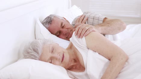 senior couple sleeping in bed