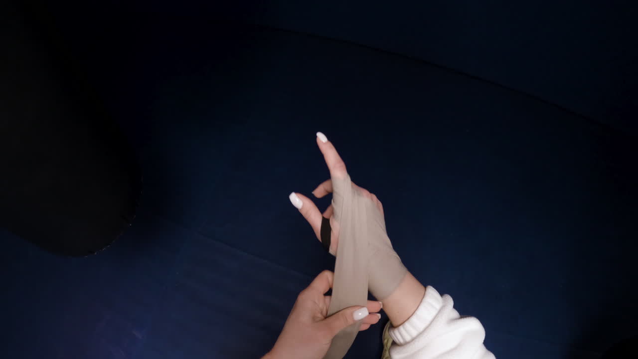 Woman wrapping boxing hand wraps