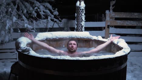 Person-taking-a-traditional-ice-bath-in-a-frozen-outdoor-pool