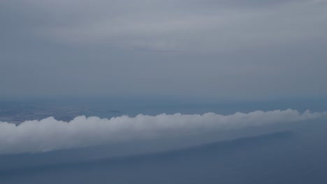 airplane flies above the clouds