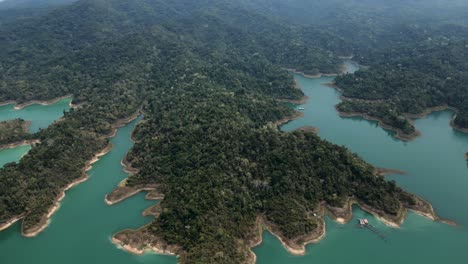 stunning aerial views of a vast turquoise reservoir with lush forested islands and remote natural beauty