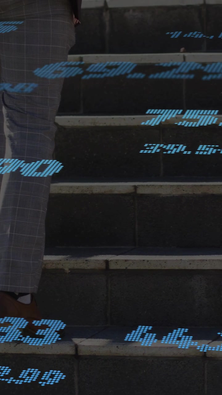 Vertical video: Man climbing steps, phone causing blue data passing around legs, showing tech