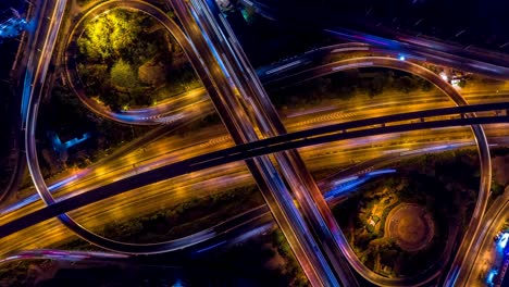 road interchange in the city at night with vehicle car light movement, aerial view.