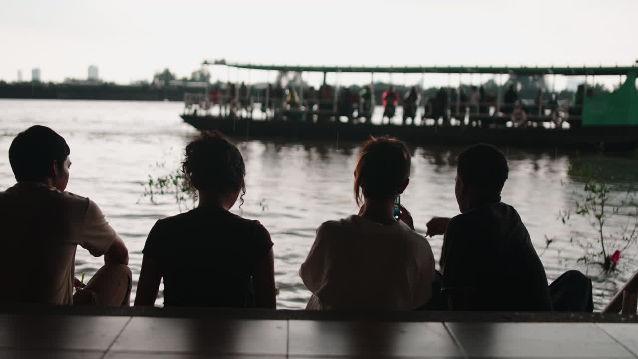 People watching a boat on the river
