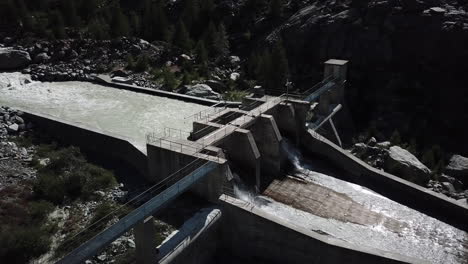 concrete installation in the mountains:hydroelectric dam seen by drone in the swiss alps