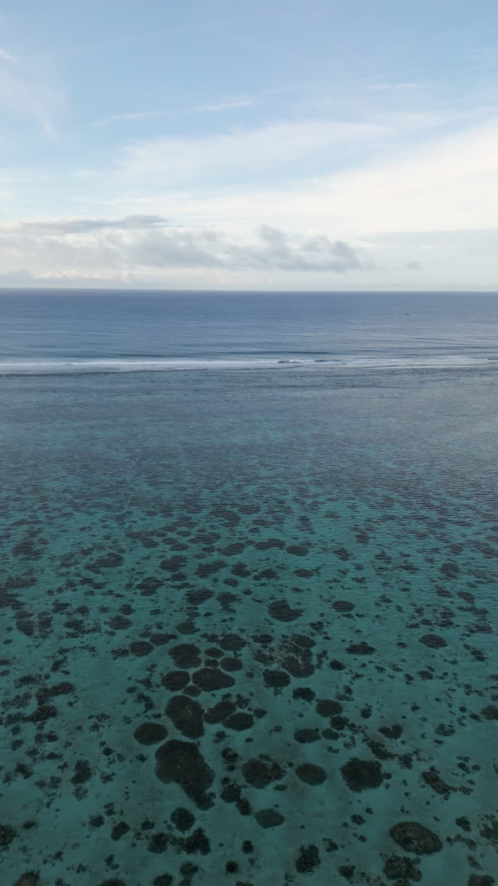 Peaceful serene backdrop of waves breaking on shallow fringing reef in ocean water
