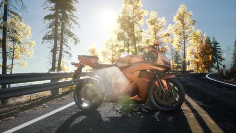 sportbike on tre road in forest with sun beams