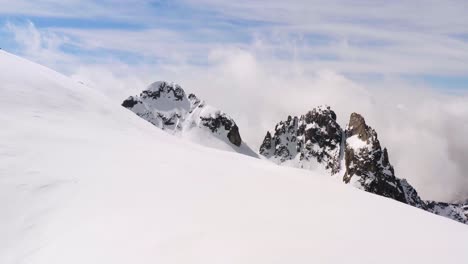 aerial reveal of pure white snow over dolomite mountains