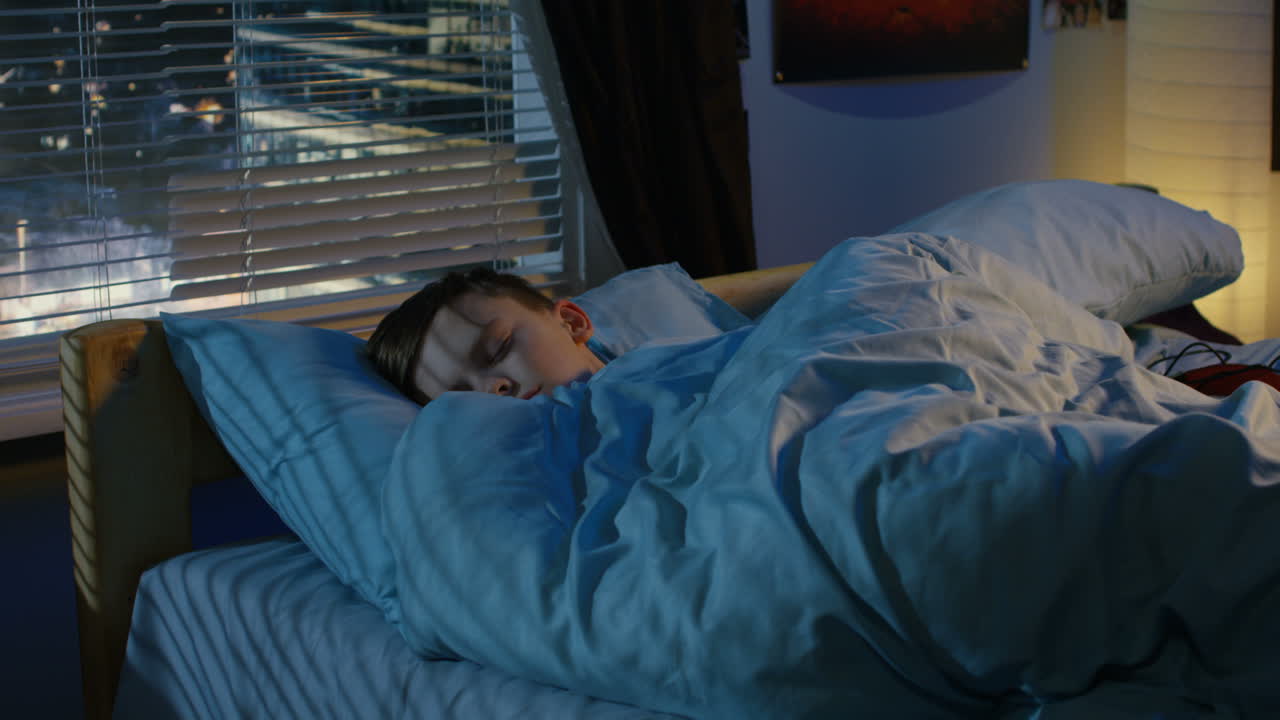 Boy Sleeping in His Bedroom at Night