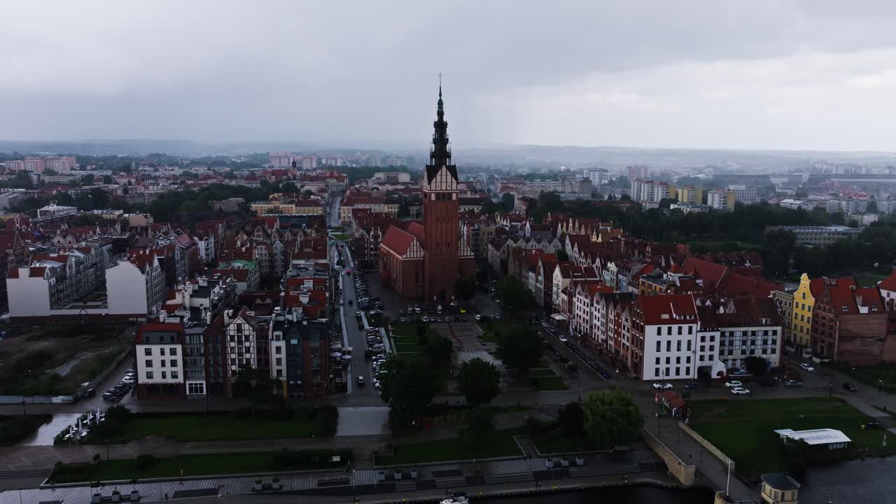 Cinematic rainy aerial of Elbląg Old Town panorama with St Nicholas Cathedral