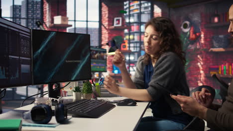 man and woman watching business conference infographics on computer setup