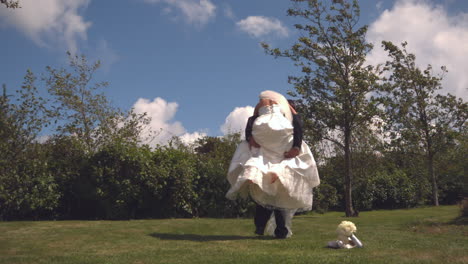 happy groom carrying his bride on piggy back