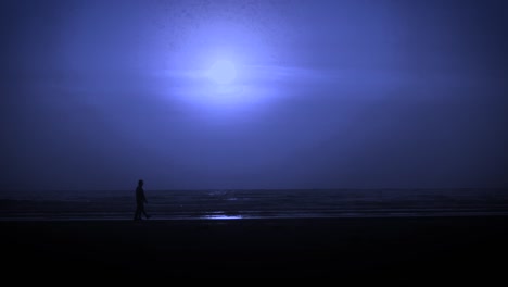 Full-moon-at-beach,-silhouette-of-two-man-walking-on-the-beach,-blue-night,-India