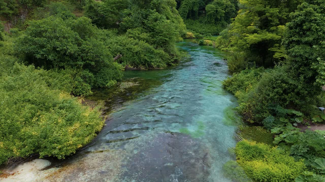 Aerial of Syri i Kaltër, the vibrant Blue Eye river spring in Albania. Gjirokastër, forest and nature