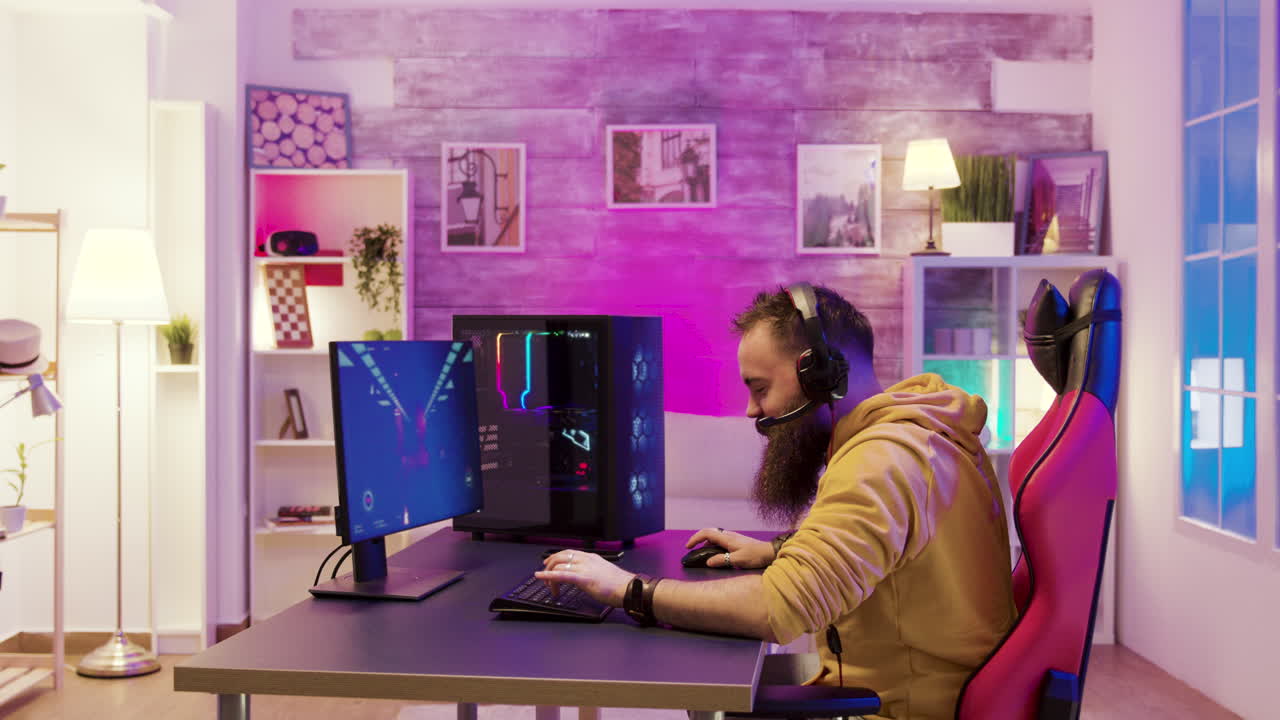 Gamer playing video games at a computer desk