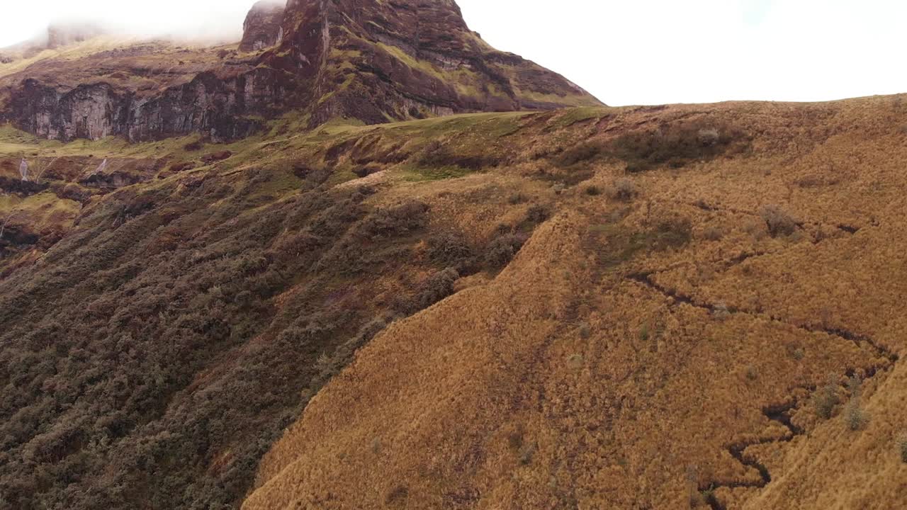 Awe-Inspiring Aerial Dolly Shot Journeying Over Casahuala's Flora Terrain with Misty Clouds Caress the Peaks of an Extinct Ecuadorian Volcano in Ecuador