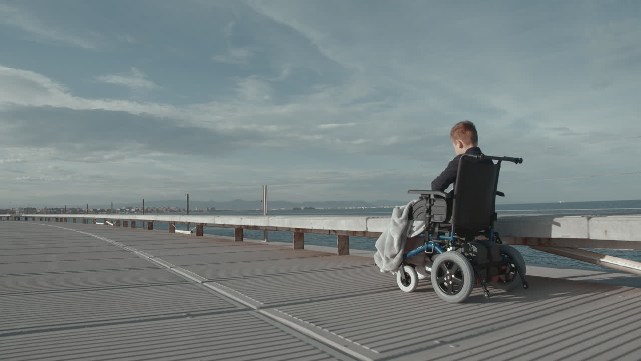 Outdoor ride of disabled child in electric wheelchair