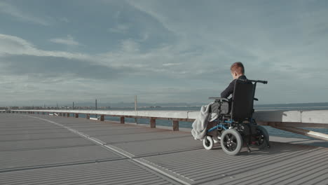 Outdoor-ride-of-disabled-child-in-electric-wheelchair